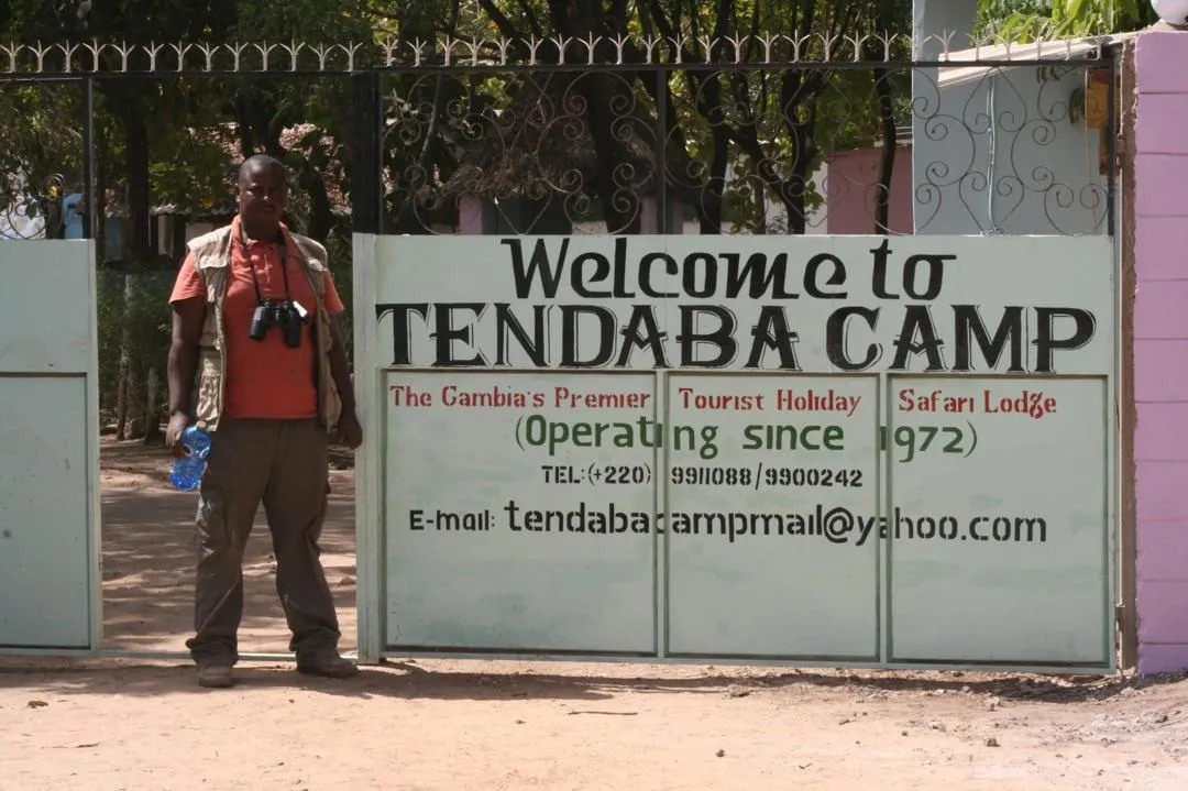 A guide at the entrance gate of Tendaba Camp, Lower River