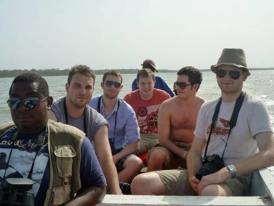 Yaya Barry and a group of guests birding by boat in The Gambia