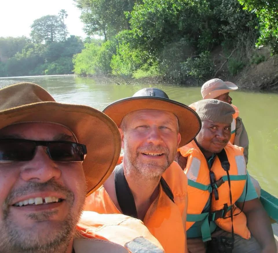 Yaya Barry with guests on a river crossing during a Gambia birding tour